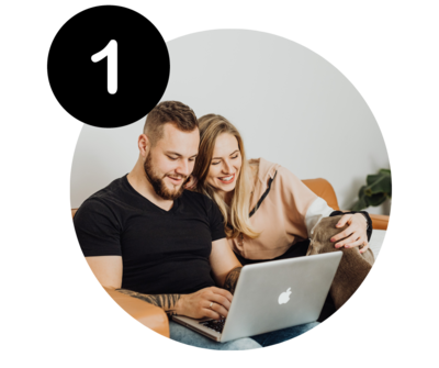 Couple using a laptop to book an appointment at Benaway Chiropractic